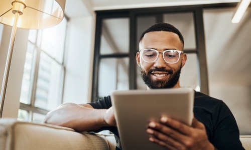 Man looking at online banking on tablet 