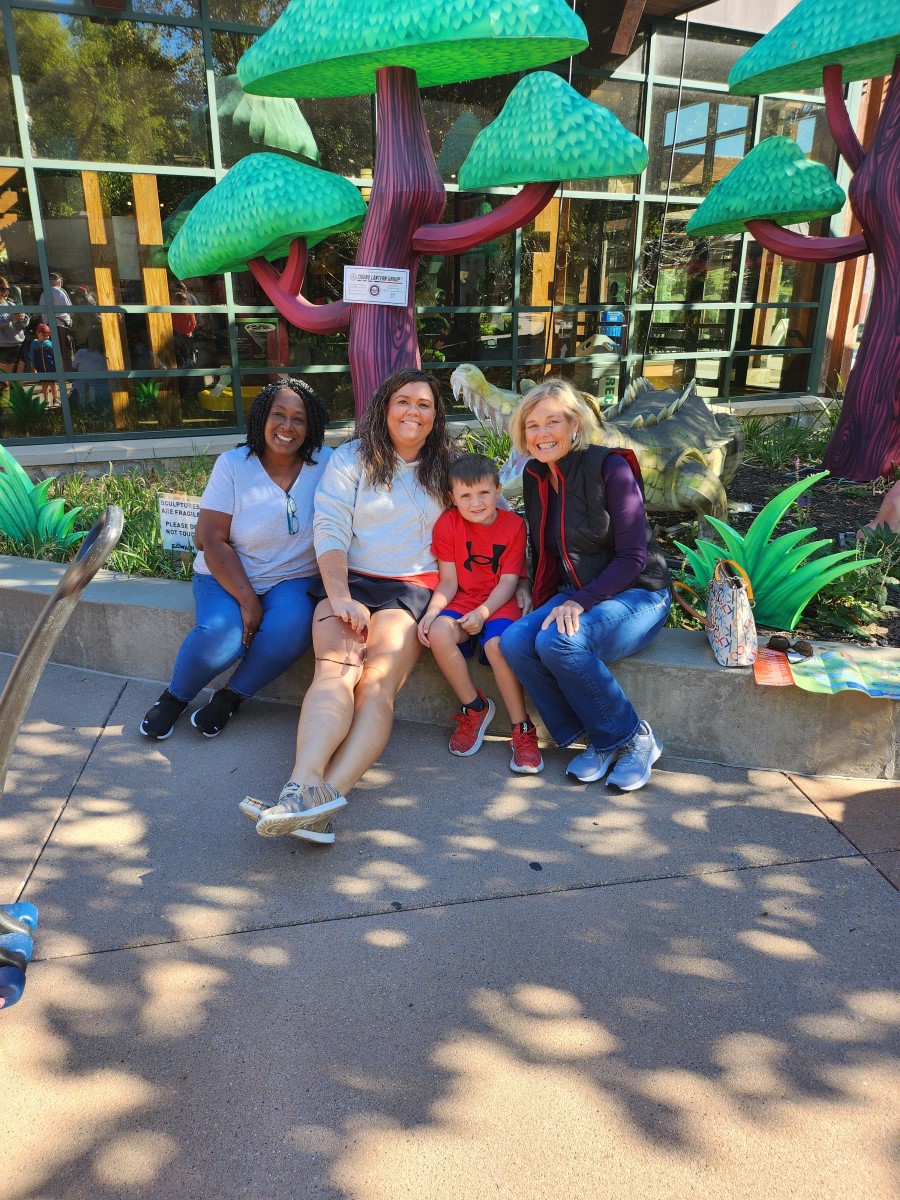 Stephanie sitting on the curb with family