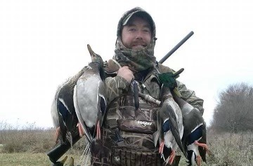 Scott holding ducks while hunting