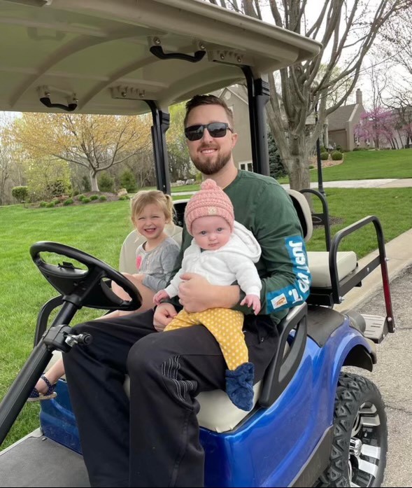 Brian on a golf cart with his kids