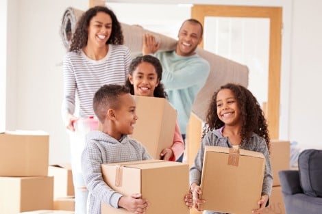 Home Turf Assistance Program A family carrying boxes