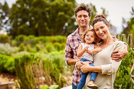 USDA Loan Family standing in a garden